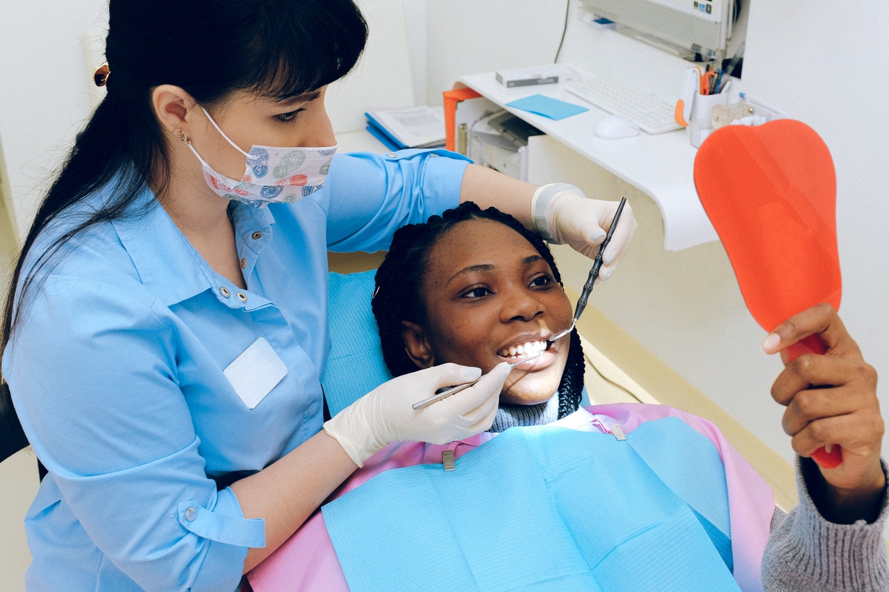Teeth Whitening Sunshine Coast - Girl in dentist chair looking in a mirror